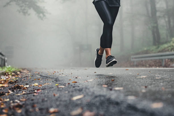 istock Unrecognizable athlete running on misty autumn day in the forest. 1340654509