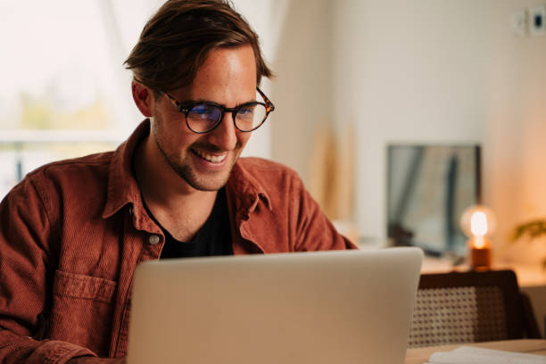 istock Caucasian male student working from home during lockdown typing on laptop at desk set up 1340654683