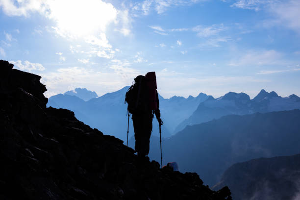 istock hiker silhouette on a mountain slope 1340654702