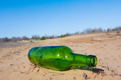 green bottle on a sand