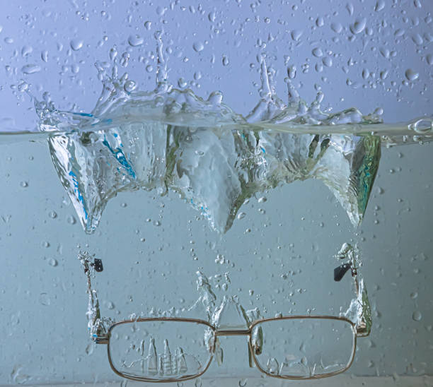 istock glasses fall into the water. sprays, drops and bubbles 1340657290