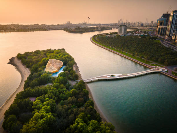 Al Noor island aerial view at Sharjah Emirate of the United Arab Emirates at sunset Sharjah, United Arab Emirates - May 26, 2021: Al Noor island aerial view at Sharjah Emirate of the United Arab Emirates above Khalid lake at sunset dubai island stock pictures, royalty-free photos & images