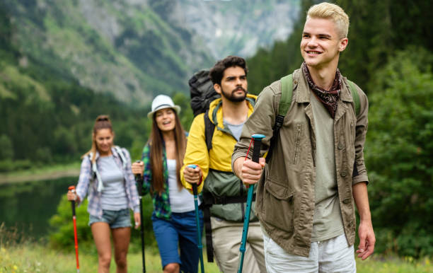 istock Group of friends with backpacks doing trekking excursion on mountain 1340659187