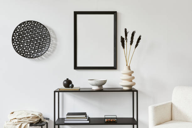 istock Minimalistic stylish composition of creative room interior design with mock up poster frame, metal shelf, armchair and personal accessories. Black and white concept. Template. 1340660485