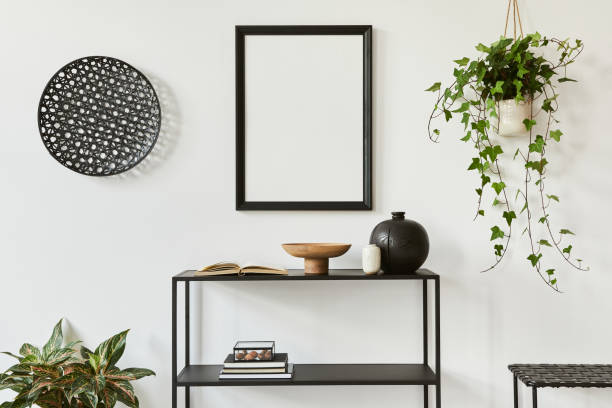 istock Minimalistic stylish composition of creative room interior design with mock up poster frame, metal shelf, plants and personal accessories. Black and white concept. Template. 1340660490