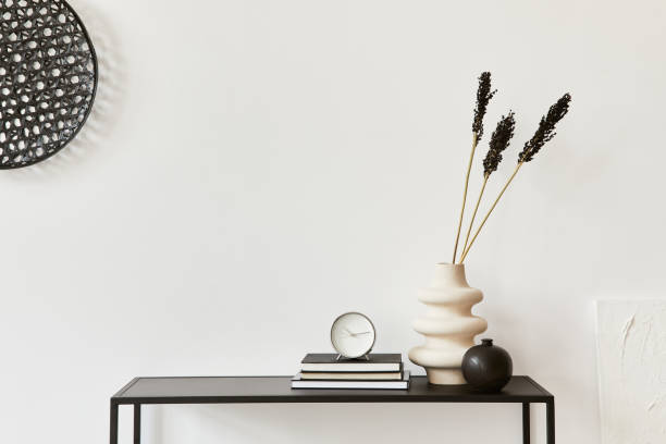 istock Minimalistic stylish interior composition of creative room with copy space, metal shelf, plants and personal accessories. Black and white concept. Template. 1340660491