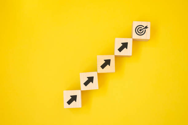 istock Virtual target board and arrow which print screen on wooden cube. Business achievement goal and objective target concept. 1340660583