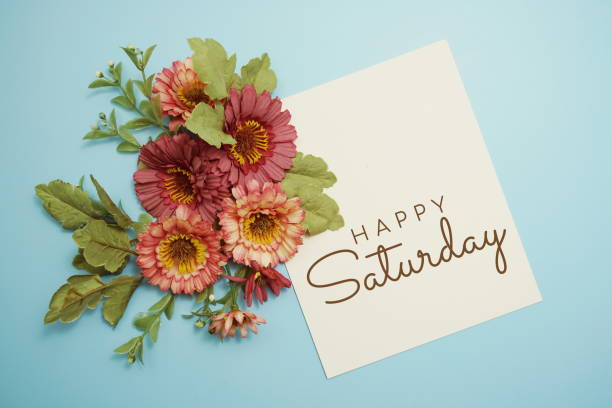 istock Happy Saturday card typography text with flower bouquet on blue background 1340660823