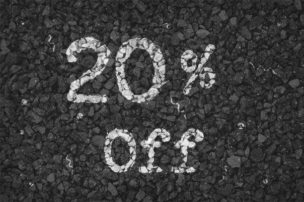istock Black  and white coloured pebbles making a  rustic poster with text 20 % Off painted on gravel road with small swirls pattern, vector backgrounds 1340660953