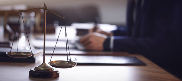 Scales of justice and blurred lawyer on background. Banner design Scales of justice and blurred lawyer on background. Banner design law stock pictures, royalty-free photos & images