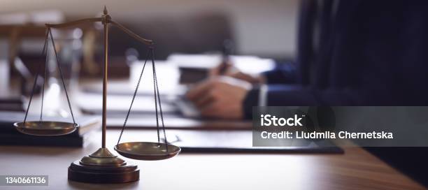 Scales Of Justice And Blurred Lawyer On Background Banner Design Stock Photo - Download Image Now