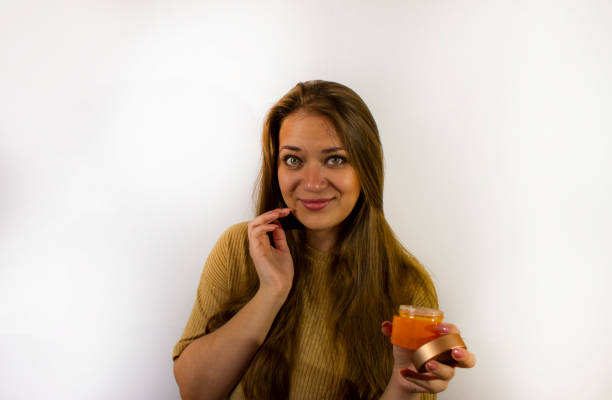 young beautiful woman uses face cream