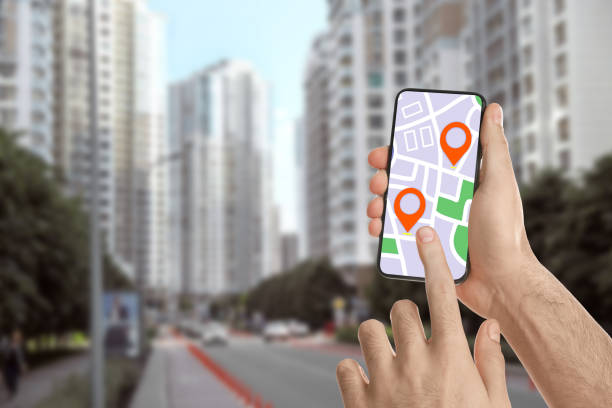 istock Man searching location with smartphone in city, closeup. Space for text 1340661209