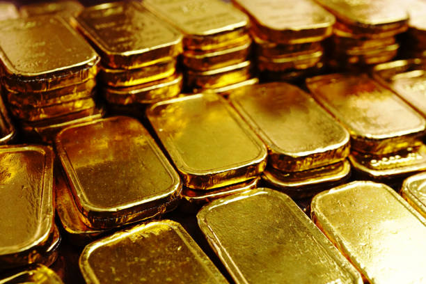 istock Group of gold bars array on the table , investment concept . 1340661886