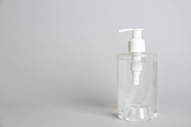 istock Dispenser bottle with antiseptic gel on light grey background. Space for text 1340661973