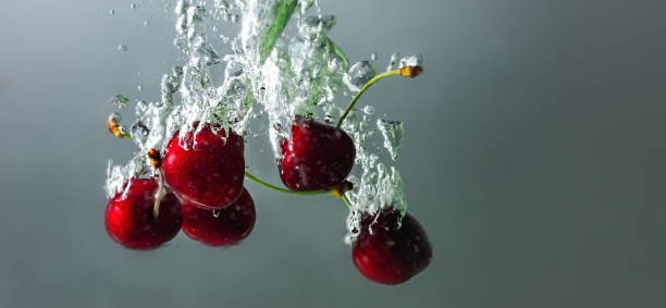 istock ripe cherries fall into the water raising splashes and air bubbles 1340662187