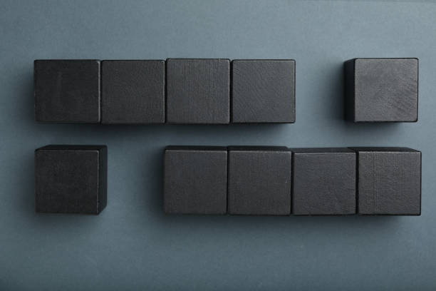 istock Flat lay composition with black cubes on dark background. Pareto principle concept 1340662493