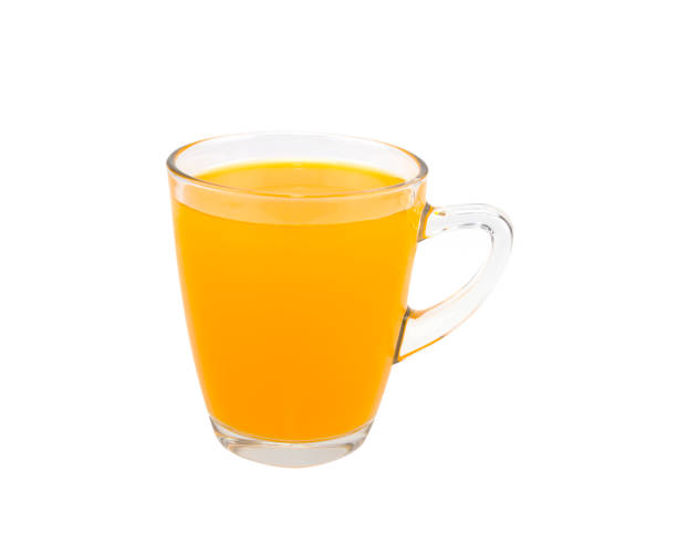 istock Orange juice in a glass isolated on white background 1340663765