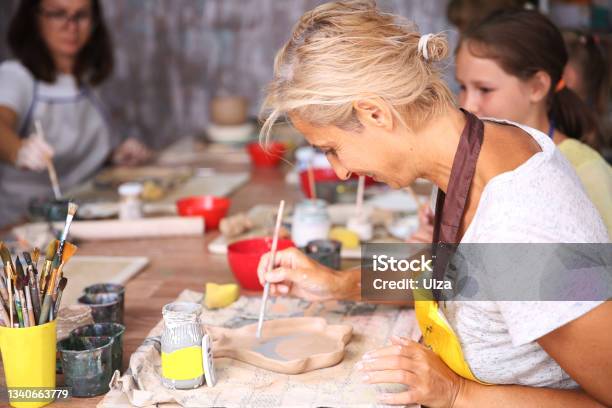 Mother And Kid Daughter Molded From Clay At Pottery Class Stock Photo - Download Image Now