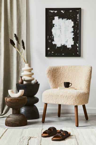 istock Creative composition of cozy living room interior design with mock up poster frame, fluffy armchair, coffee table and personal accessories. Modern classic style. Template. 1340664664