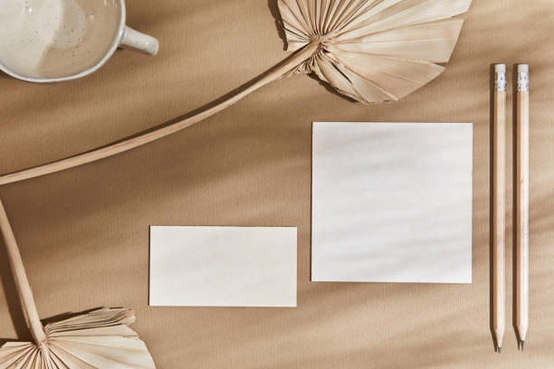 istock Flat lay creative interior composition with mock up visit cards, textile, pencil,  rocks, wood, natural materials, dry plants and personal accessories. Neutral colours, top view, template. 1340664987
