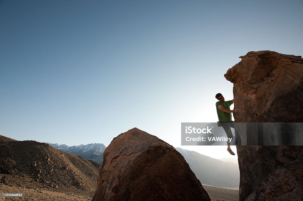arete A man climbing a boulder Activity Stock Photo