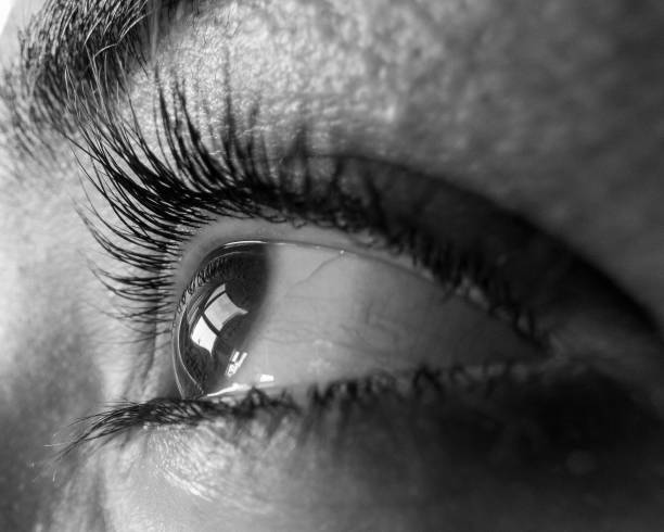 woman eye looking out the windows with black and white illusion