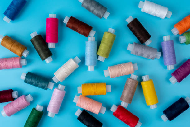 istock Colorful sewing thread in the studio on a blue color background 1340668881