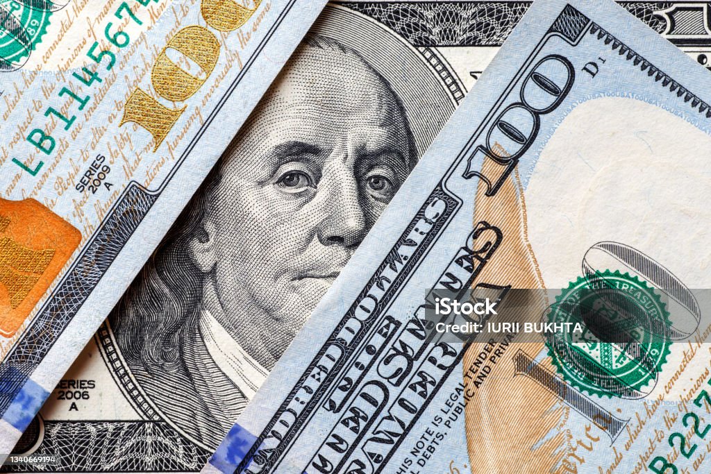 Money american hundred dollar bills.Closeup of assorted American banknotes.US currency scattered on the table.america currency dollor currency.World economic crisis associated with coronovirus. US Paper Currency Stock Photo