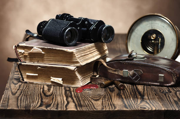 istock A stack of old books, binoculars, a barometer, a worn leather case and two cartridges 1340670213