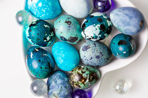 istock Easter blue quail eggs in a plate in the shape of a heart on a white table 1340672432