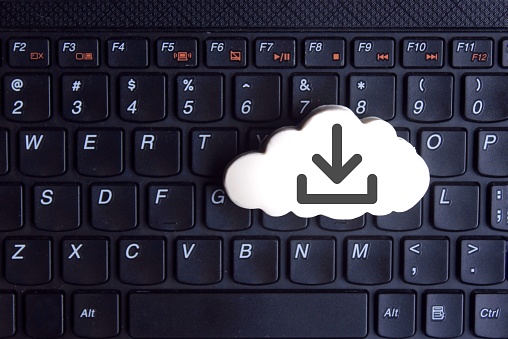 Technology, cloud computing concept. White cloud with download icon on keyboard