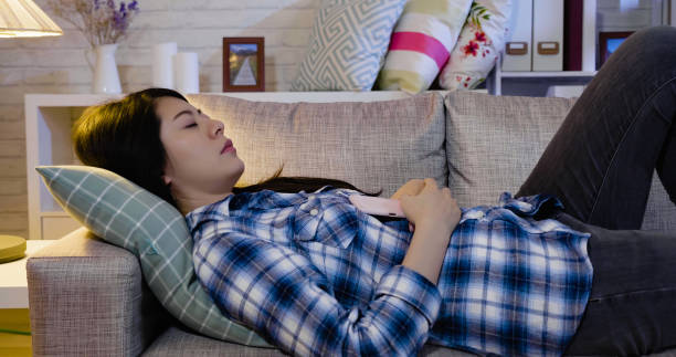 istock beautiful asian young woman sleeping on couch 1340672779