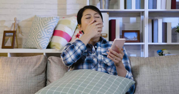 istock female holding smartphone look exhausted 1340672841