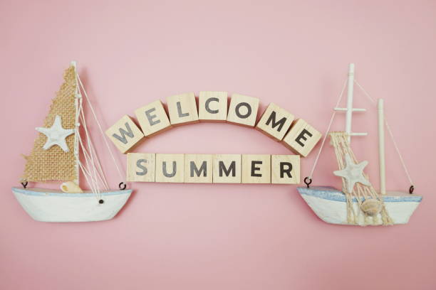 istock Welcome Summer message alphabet letter with sailboat on pink background 1340674292