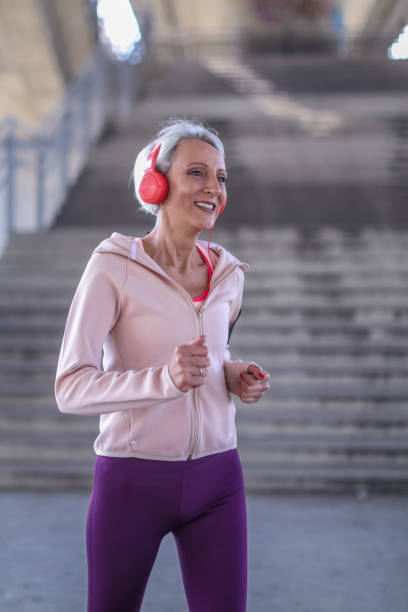 istock Senior athletic woman jogging outside 1340675058