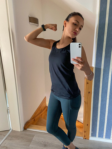 Woman taking a selfie before going to gym with sport clothes.