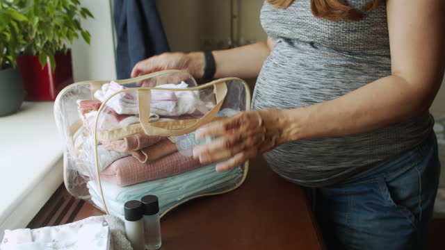Pregnant woman preparing bag for the hospital for childbirth