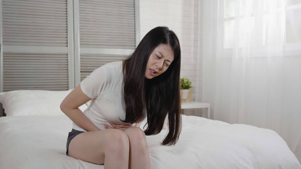 istock girl stomach hurt resting at home. 1340675367