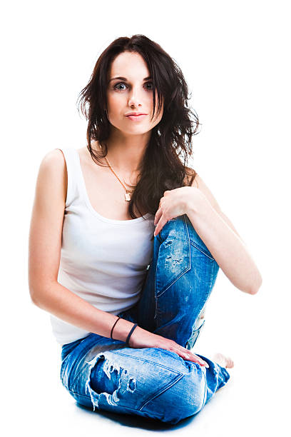istock Pretty woman in blue jeans sitting on white floor 134067540