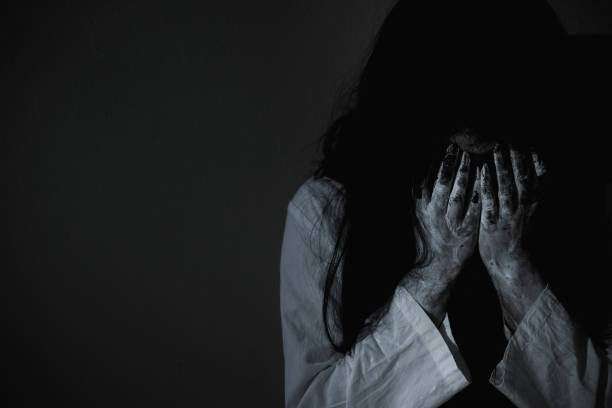 Woman ghost horror sitting crying and have her hands close the face, Woman ghost horror sitting crying and have her hands close the face, halloween concept exorcism stock pictures, royalty-free photos & images