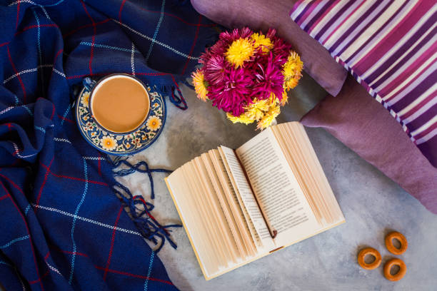 Autumn composition. Coffee chrysanthemums book plaid top view flat layout