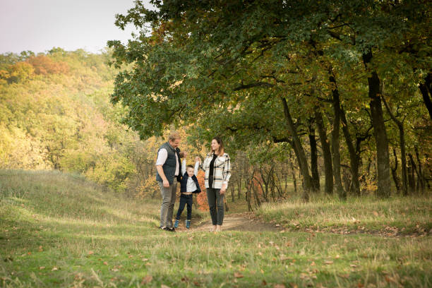 fall. close-up of happy family on the background of the autumn forest. happy mom, dad and son are walking in the woods and playing. - n64 imagens e fotografias de stock