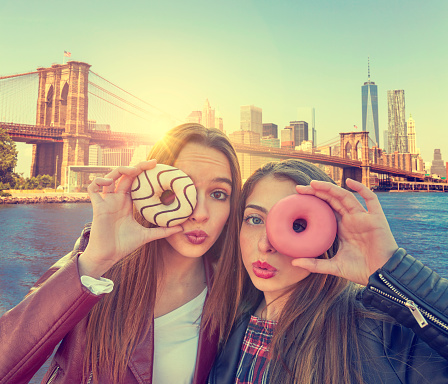Teen girls portrait with donuts in eye in New York photomount Manhattan
