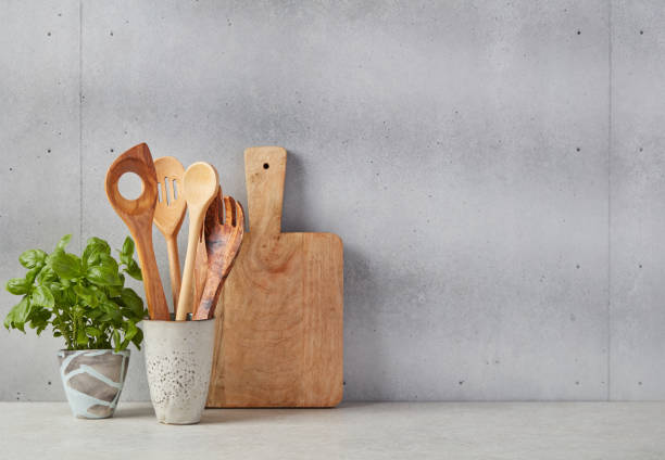istock Wooden cutting board, spoons and basil 1340682469
