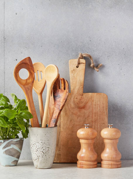 istock Cutting board, spoons, salt and pepper and basil 1340682513