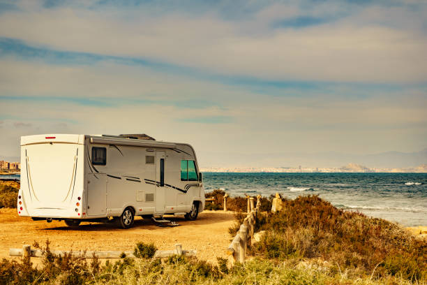 Camper camping on sea, Spain Camper camping on mediterranean coast of seaside spanish Santa Pola city, Costa Blanca rv stock pictures, royalty-free photos & images