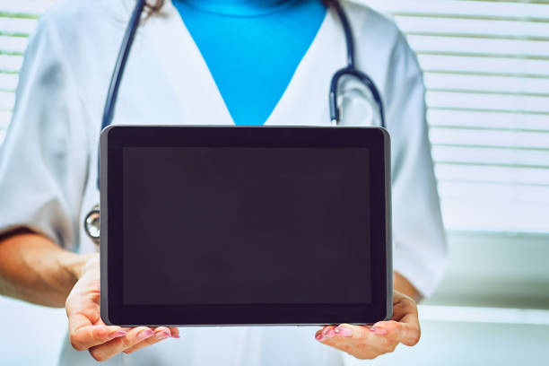 Woman doctor using tablet computer in hospital