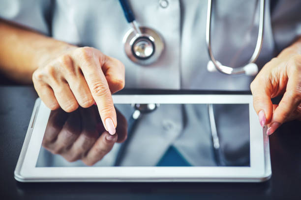 istock medical doctor woman smile hold tablet pc, using computer. 1340689626