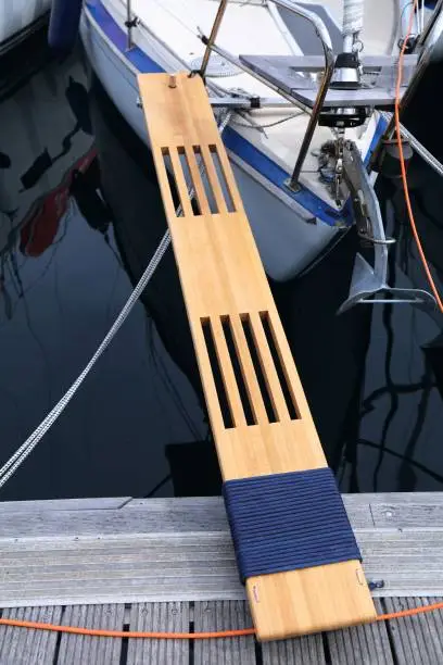 Sailing in Dubrovnik, Croatia. Sailing yacht wooden boarding gangway (gangplank) mounted to the front of the boat in a marina.